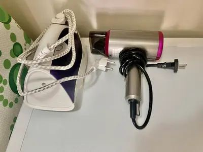 a hairdryer and a shoe in a holder at Sunny in Varna City