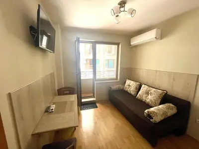 a living room with a couch and a table at Sunny in Varna City