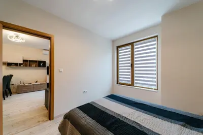 a bedroom with a bed and a window at Апартамент за гости Веси in Burgas City