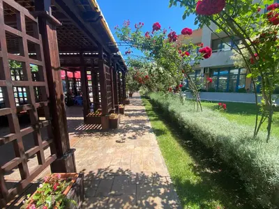 a brick walkway next to a building with flowers at Two bedroom apartment in Trakia Sunny Beach in Sunny Beach