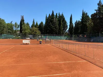 a tennis court with a bench on a tennis court at Two bedroom apartment in Trakia Sunny Beach in Sunny Beach