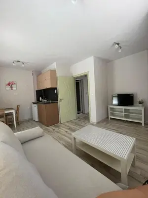 a living room with a couch and a table at Къща за гости “Недев” in Tsarevo