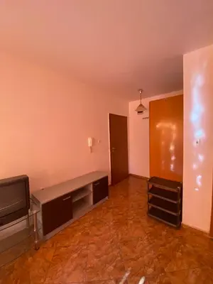 an empty living room with a television and a couch at Studios & Apartments Perla in Sunny Beach