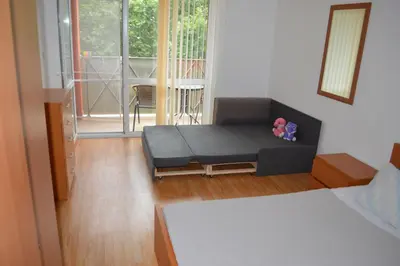 a living room with a couch and a balcony at Gerber Residence 2 in Sunny Beach