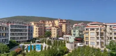 a group of buildings in a city with a pool at Sun Wave Apartment Presige in Sveti Vlas