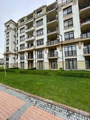 a large apartment building with a lawn in front of it at Aivazovski park - Pomorie SP apartments in Pomorie