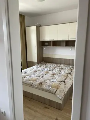 a bedroom with a large bed with white cabinets at Aivazovski park - Pomorie SP apartments in Pomorie