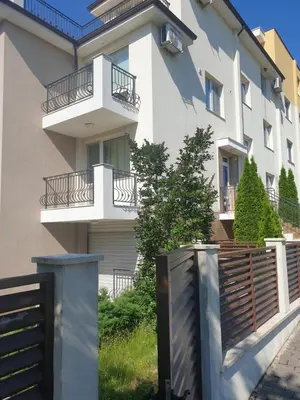 a building with balconies and a fence in front of it at Seaside 1-BR Apartment with Pool Access in Byala