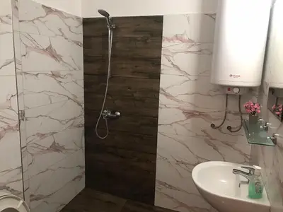 a bathroom with a shower and a sink at Апартамент Хармония in Sozopol