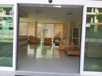 an open glass door of a lobby with chairs and tables at Апартамент BLUE SUMMER - уют, близо до морето in Burgas City