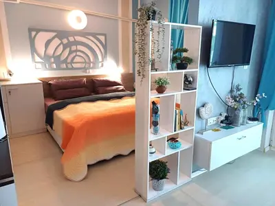 a bedroom with a bed and a book shelf at Апартамент BLUE SUMMER - уют, близо до морето in Burgas City