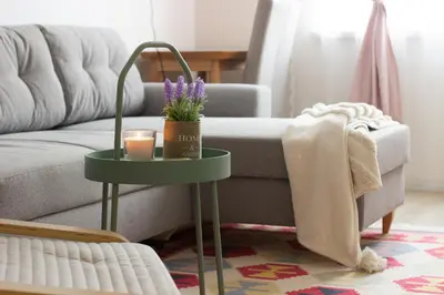 a living room with a couch and a table with a candle at COZZIE by RV Apartments in Varna City