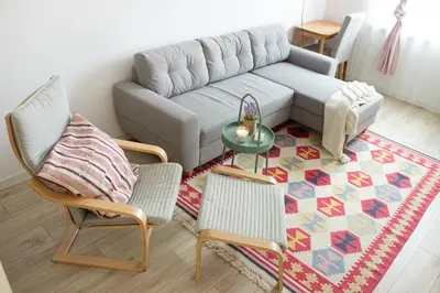 a living room with a couch and two chairs and a table at COZZIE by RV Apartments in Varna City