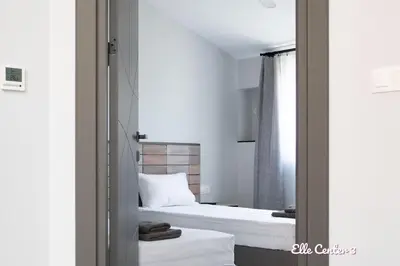 a bedroom with a bed and a mirror at Elle Center by RV Apartments - TOP center in Varna City