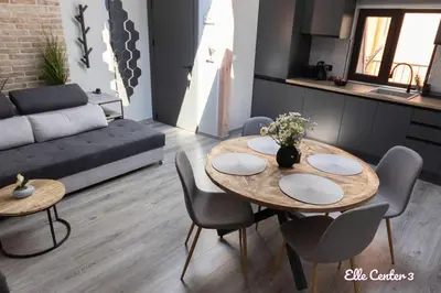 a living room with a table and chairs and a couch at Elle Center by RV Apartments - TOP center in Varna City