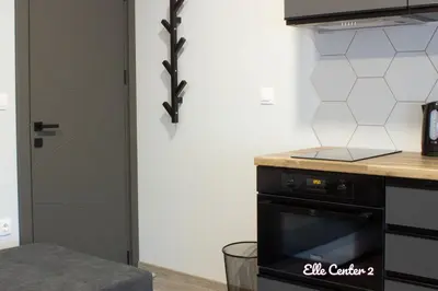 a kitchen with a stove top oven next to a door at Elle Center by RV Apartments - TOP center in Varna City