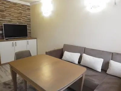 a living room with a couch and a table at Санта Марина in Varna City
