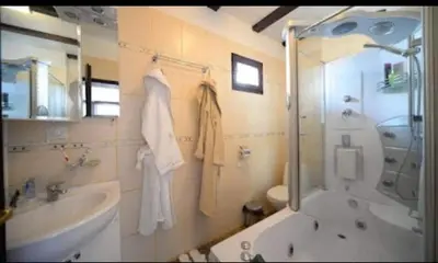 a bathroom with a shower and a sink and a toilet at Къща за гости АЛЛА in Byala