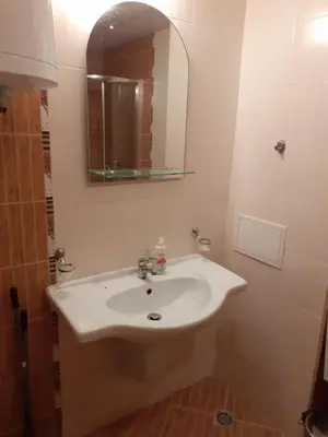 a bathroom with a white sink and a mirror at Апартамент Полюси 2 in Sunny Beach