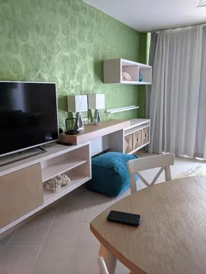 a living room with a television and a table at Solero in Pomorie