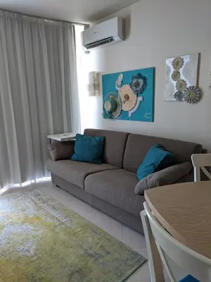 a living room with a couch and a table at Solero in Pomorie
