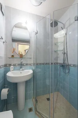 a bathroom with a sink and a glass shower at Solero in Pomorie