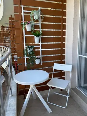 a white table and two chairs on a patio at Studio B28 Sunny Island Chernomorez in Chernomorets