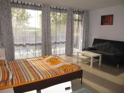 a bedroom with a bed and a living room with a couch at Apartments and studios in Cote d’Azure in Sunny Beach