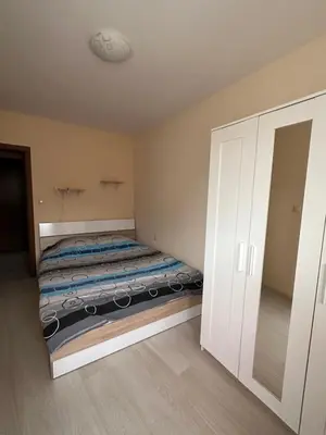a small bedroom with a bed and a closet at Apartment Starfish in Varna City