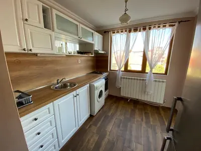 a kitchen with a sink and a washing machine at Апартамент 