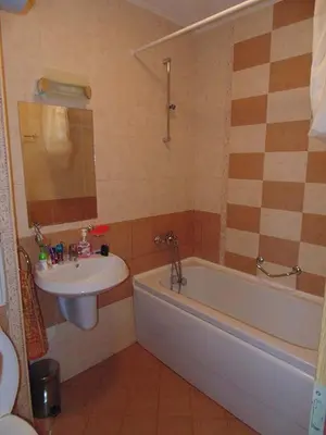 a bathroom with a sink and a tub and a toilet and a sink at One bedroom guest suite in Sunny Beach
