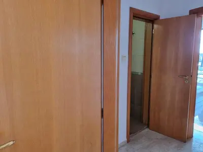 a bathroom with a wooden closet and a door at Luxsus Apartment Diamond Sveti Vlas in Sveti Vlas