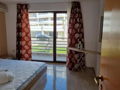 a bedroom with a bed and a sliding glass door at Luxsus Apartment Diamond Sveti Vlas in Sveti Vlas