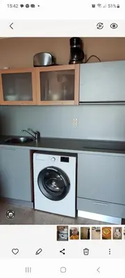 a kitchen with a microwave and a washing machine at Luxsus Apartment Diamond Sveti Vlas in Sveti Vlas