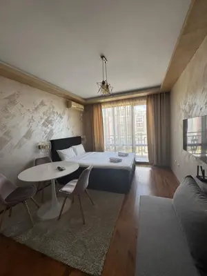 a bedroom with a bed and a table and chairs at MitProt Panorama Bay 2 Luks Studio 159 in Sveti Vlas