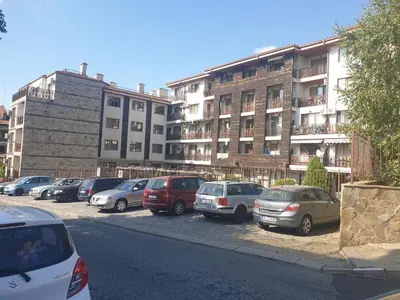 a row of cars parked in front of a building at MitProt Panorama Bay 2 Luks Studio 159 in Sveti Vlas