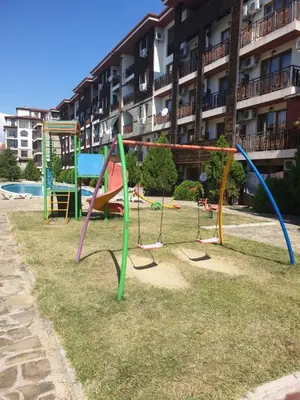 a playground in front of a apartment building at MitProt Panorama Bay 2 Luks Studio 159 in Sveti Vlas