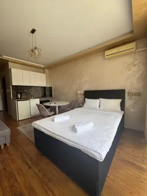 a bedroom with a large bed and a kitchen at MitProt Panorama Bay 2 Luks Studio 159 in Sveti Vlas