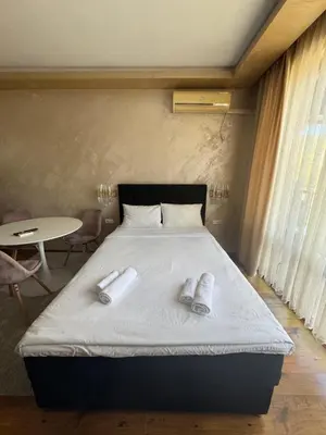a bedroom with a bed with two slippers on it at MitProt Panorama Bay 2 Luks Studio 159 in Sveti Vlas