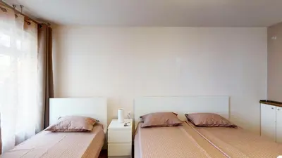 two beds sitting next to each other in a room at Markoni 4 in Burgas City
