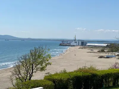 a beach with a lighthouse in the water at Markoni 4 in Burgas City