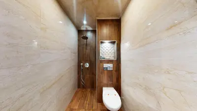 a bathroom with a toilet and a wall with marble at Markoni 5 in Burgas City