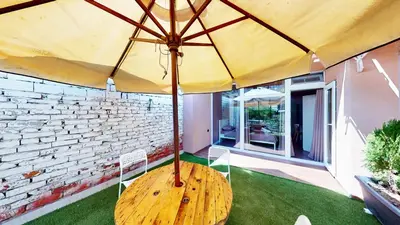 a large yellow umbrella sitting on top of a lawn at Markoni 5 in Burgas City