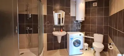 a bathroom with a washing machine and a washer at Александър Студио in Sveti Vlas