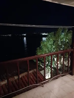 a view of the water from a balcony at night at Къща за гости Кая in Sozopol