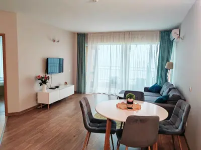 a living room with a table and a couch at Apartment Sunrise Pomorie in Pomorie