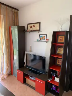 a living room with a flat screen tv on a entertainment center at Апартамент Silver Star in Sozopol
