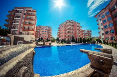 a swimming pool in a city with tall buildings at Apartmán TTT in Burgas City