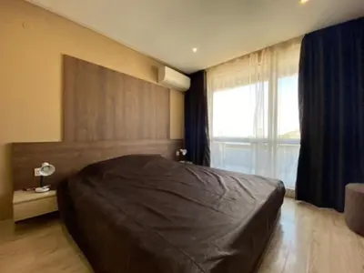 a bedroom with a large bed and a large window at PARADISO 'B' 605 Private Apartment Nessebar in Nesebar