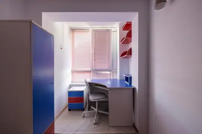 an office with a blue desk and a chair at Promenade Rooftop Flat in Varna City